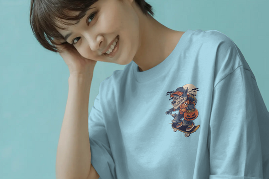 Woman wearing a light blue t-shirt with a colorful graphic on a light green background