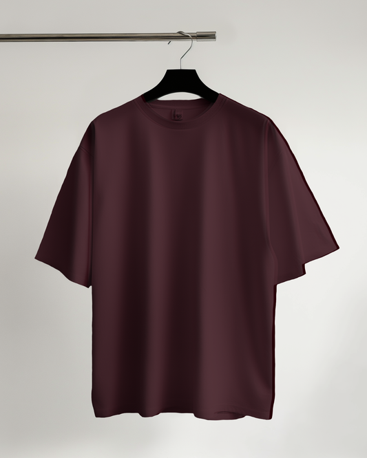 Maroon t-shirt on a hanger against a plain background