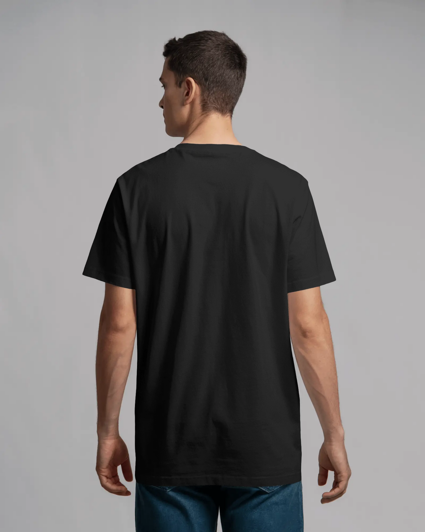 Person wearing a black t-shirt on a gray background