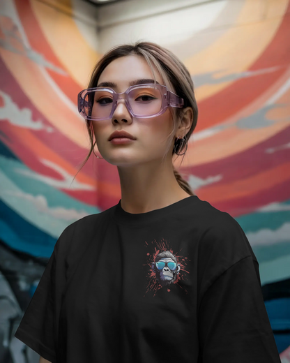 Women wearing a black t-shirt with a graphic design in front of a colorful mural.