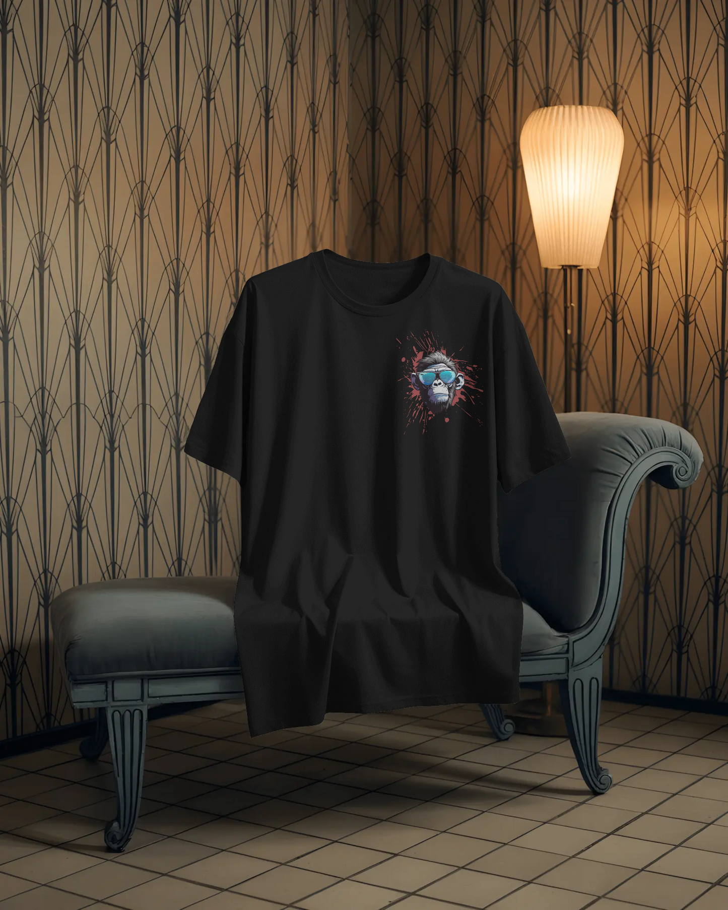 Black t-shirt with a colorful graphic design on a chair against a patterned wall.