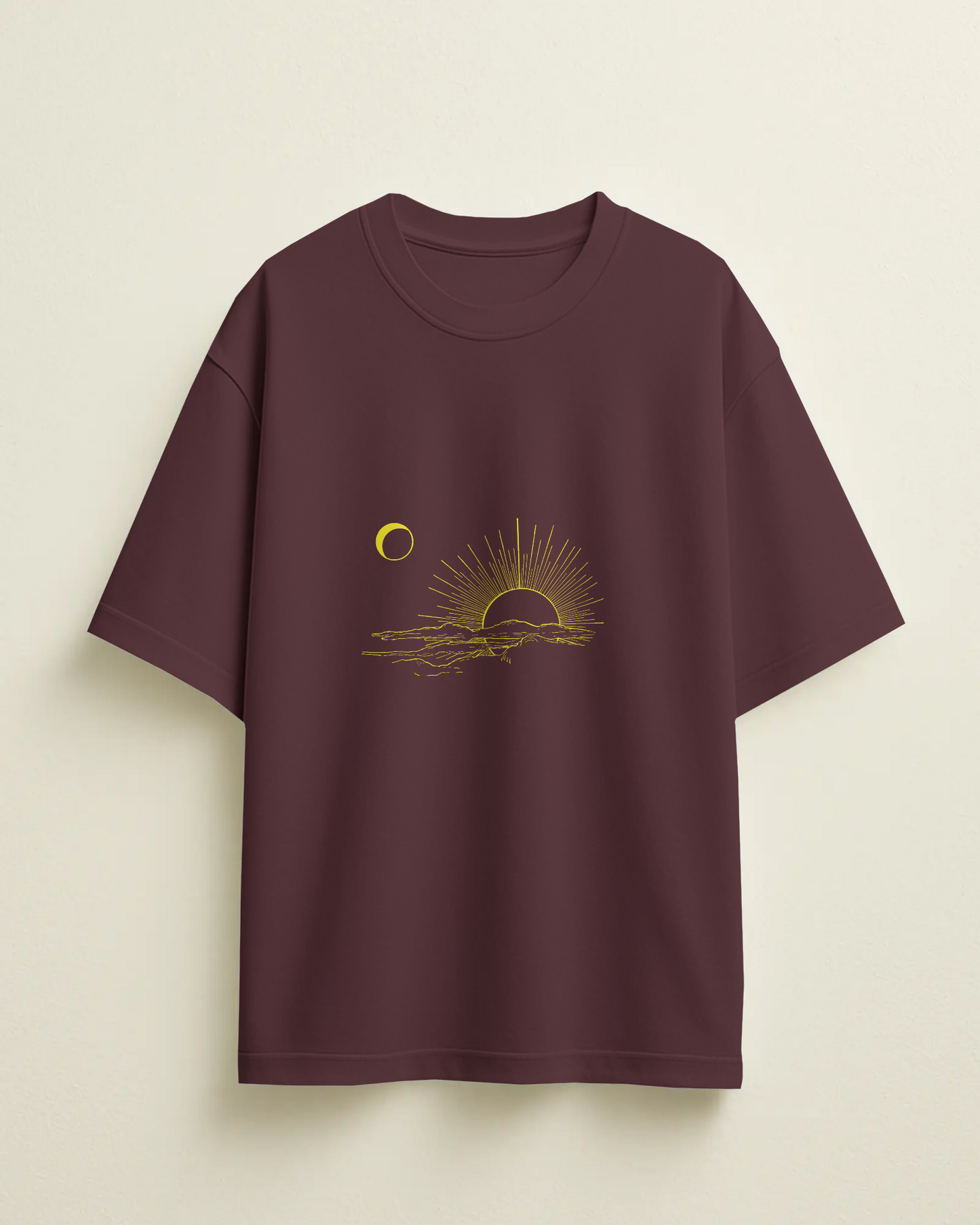 Maroon t-shirt with a sun and moon graphic on a beige background