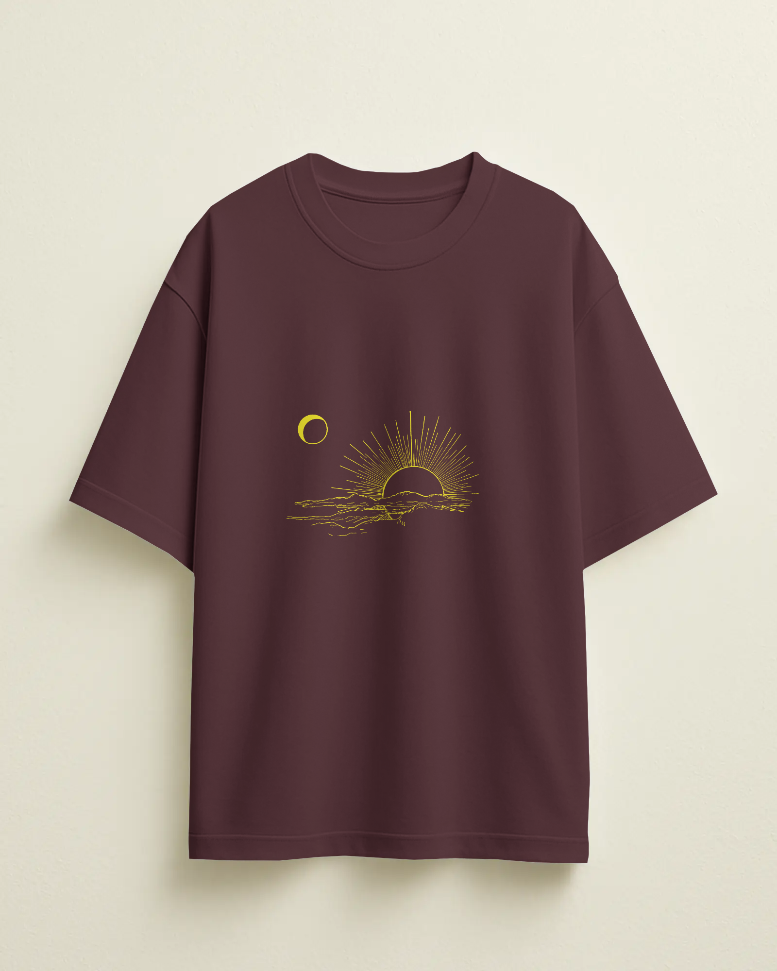 Maroon t-shirt with a sun and moon graphic on a beige background