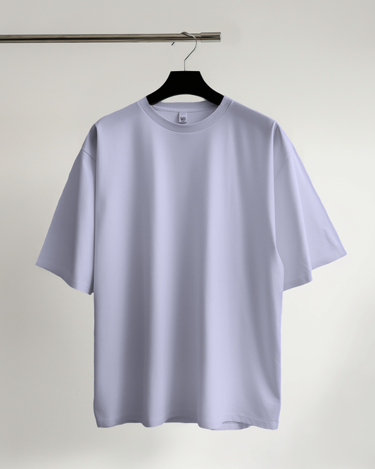 Light purple t-shirt on a hanger against a plain background